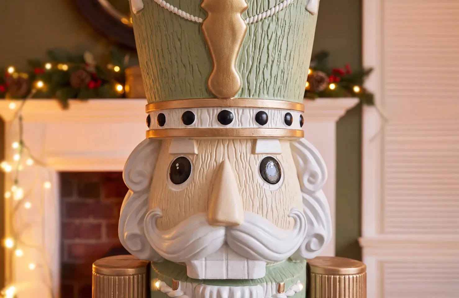 Close-up of the Otto nutcracker's face, with his gold-banded hat and curled white moustache